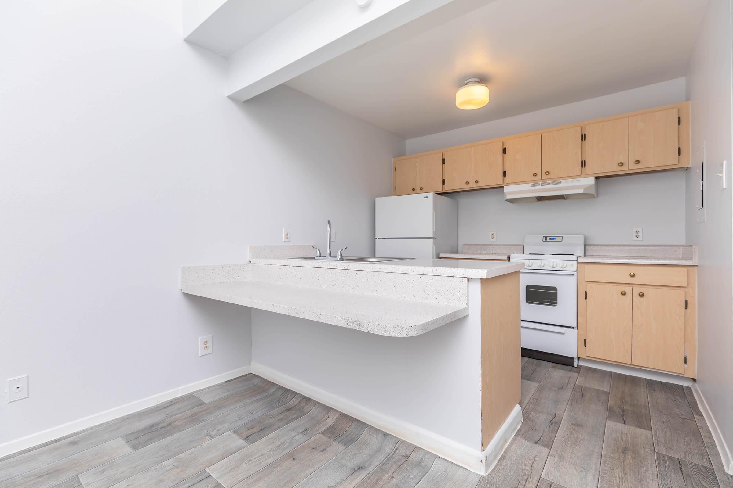 a kitchen with a sink and a refrigerator