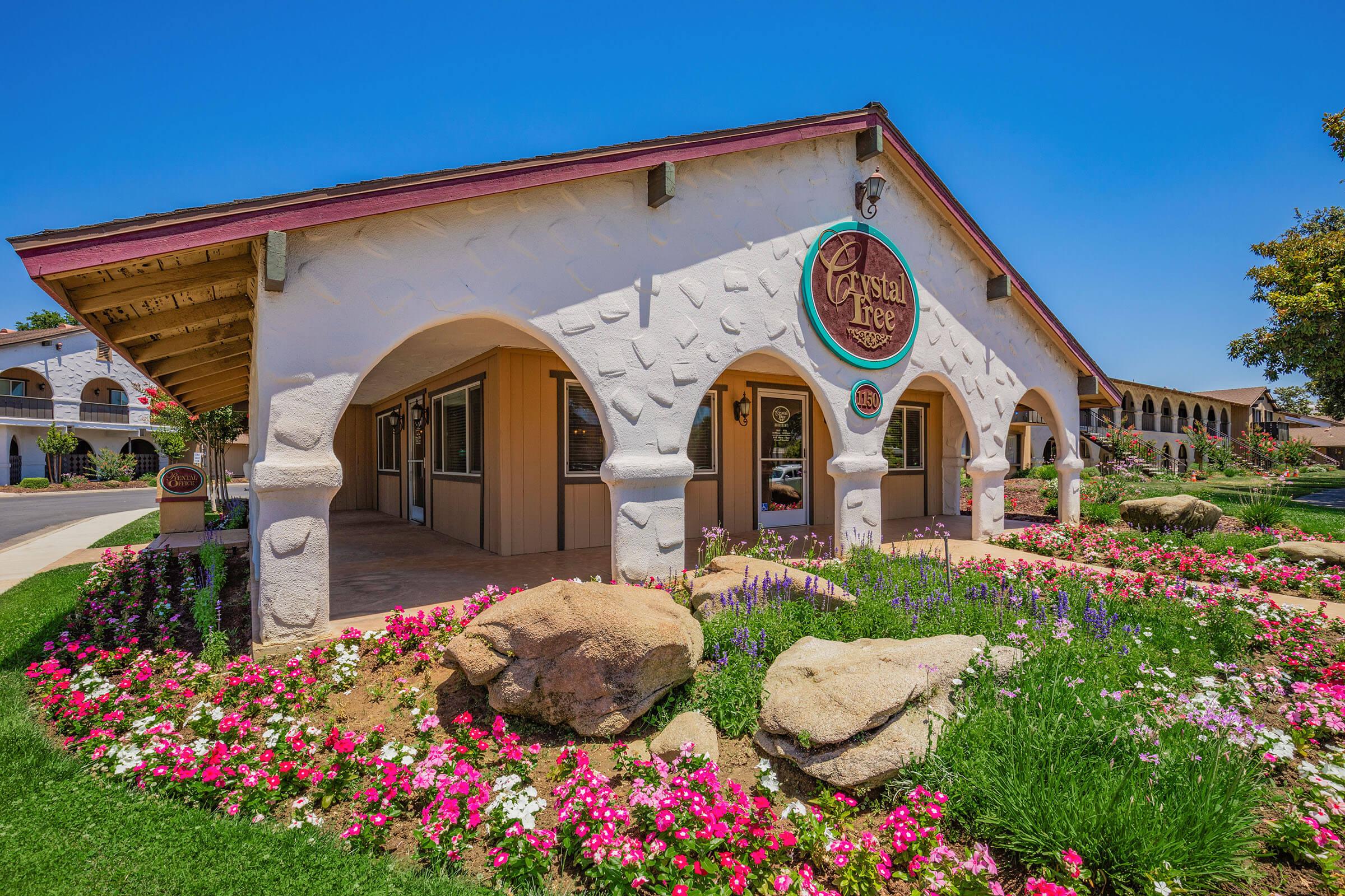 a colorful flower garden in front of a building