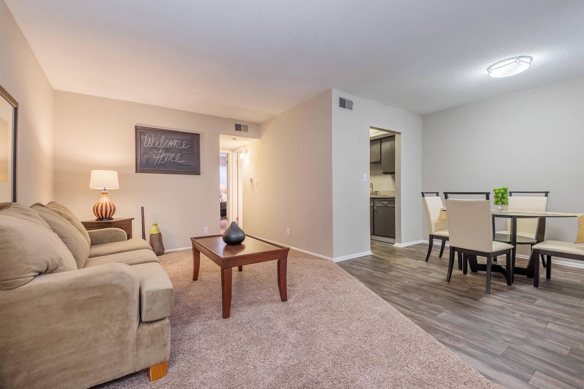 a living room filled with furniture and a flat screen tv