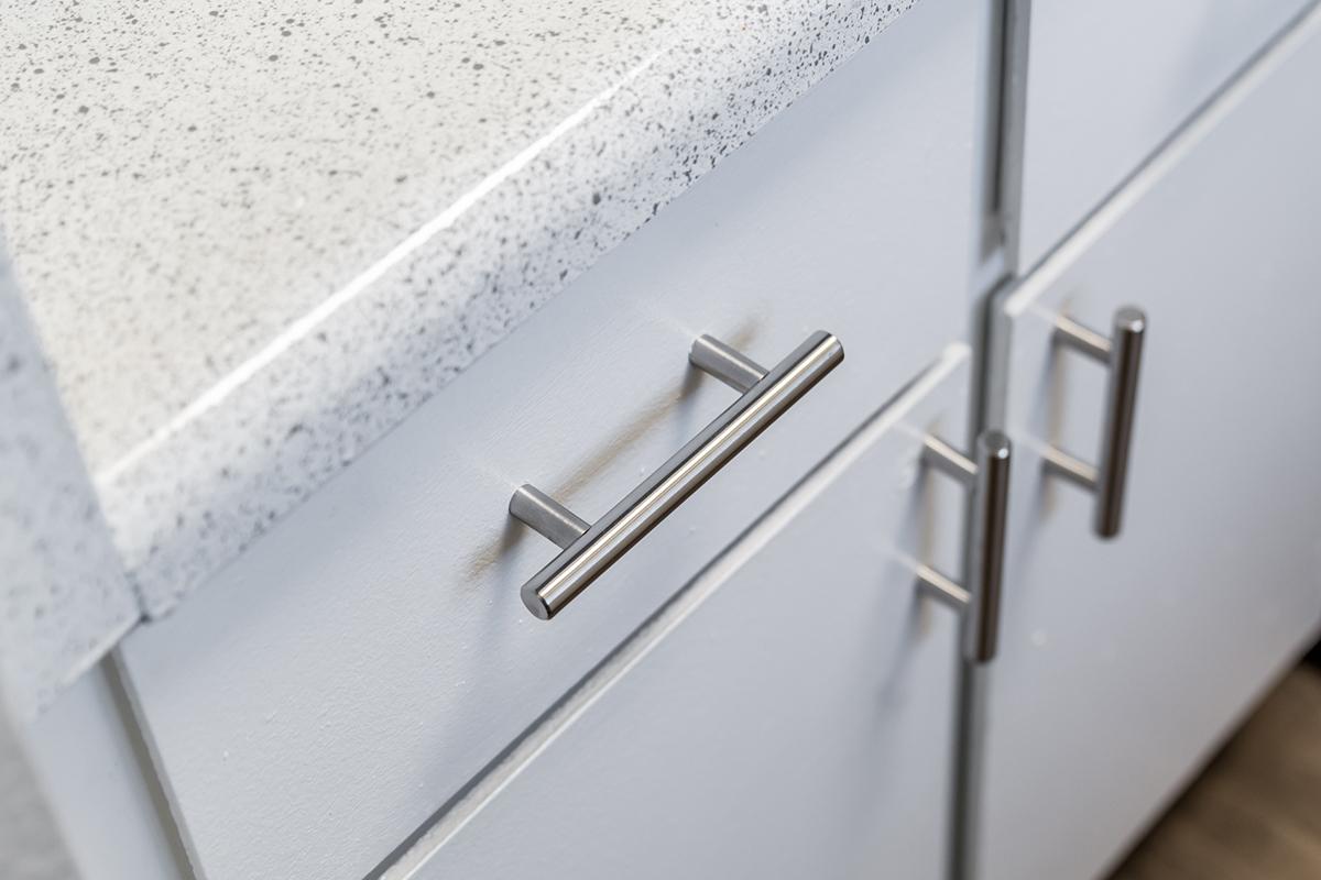 Close of view of silver hardware on kitchen cabinets and drawers