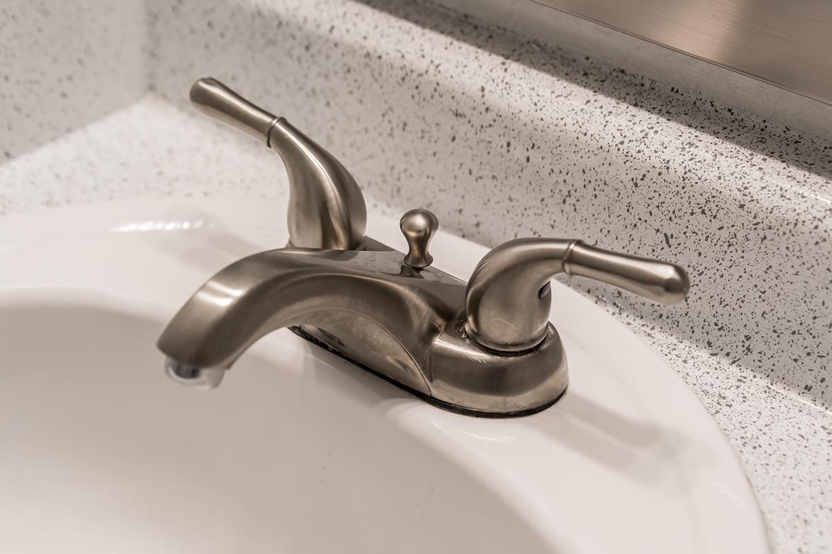 Close up view of sink faucet