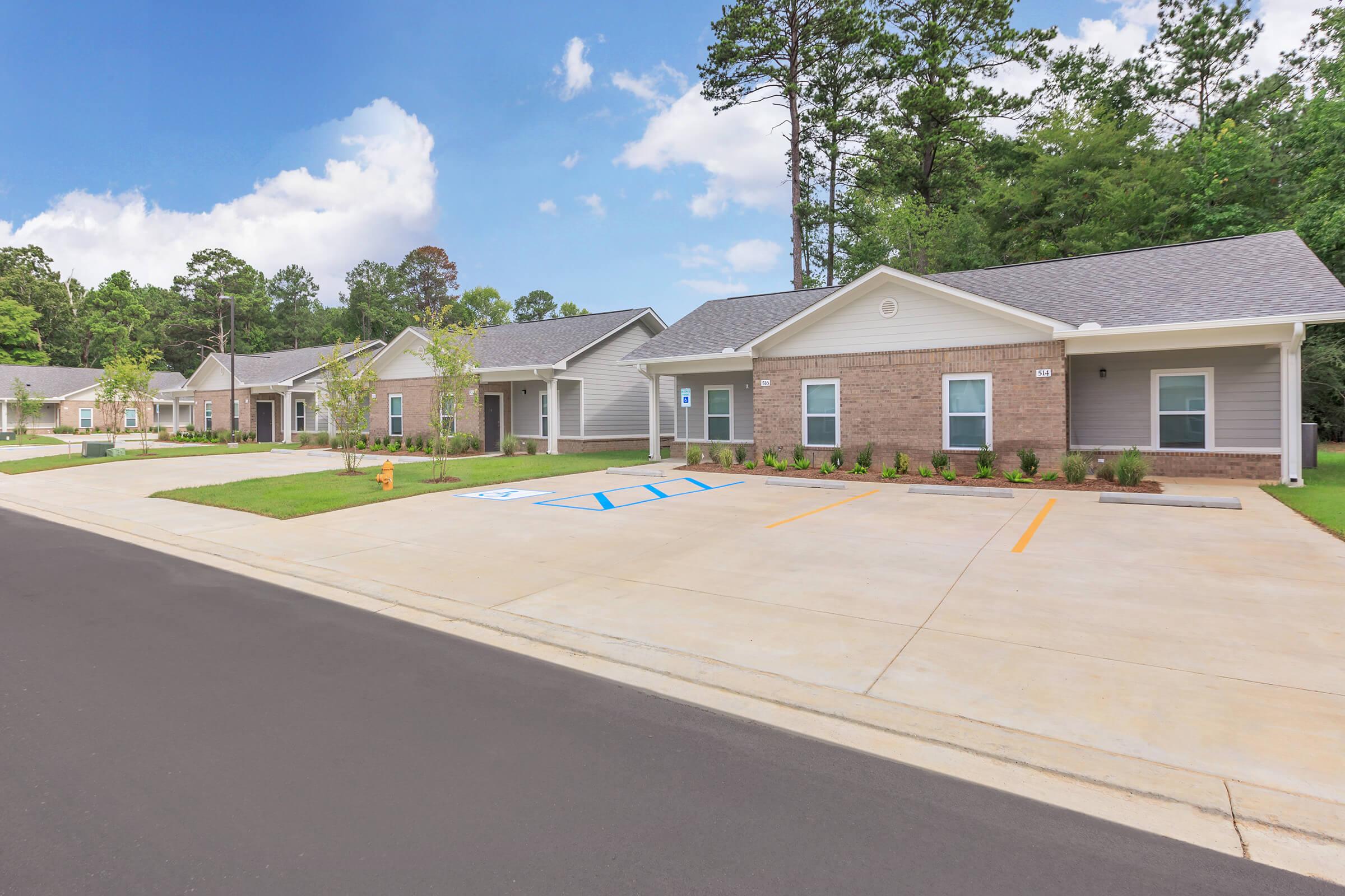 an empty parking lot in front of a house