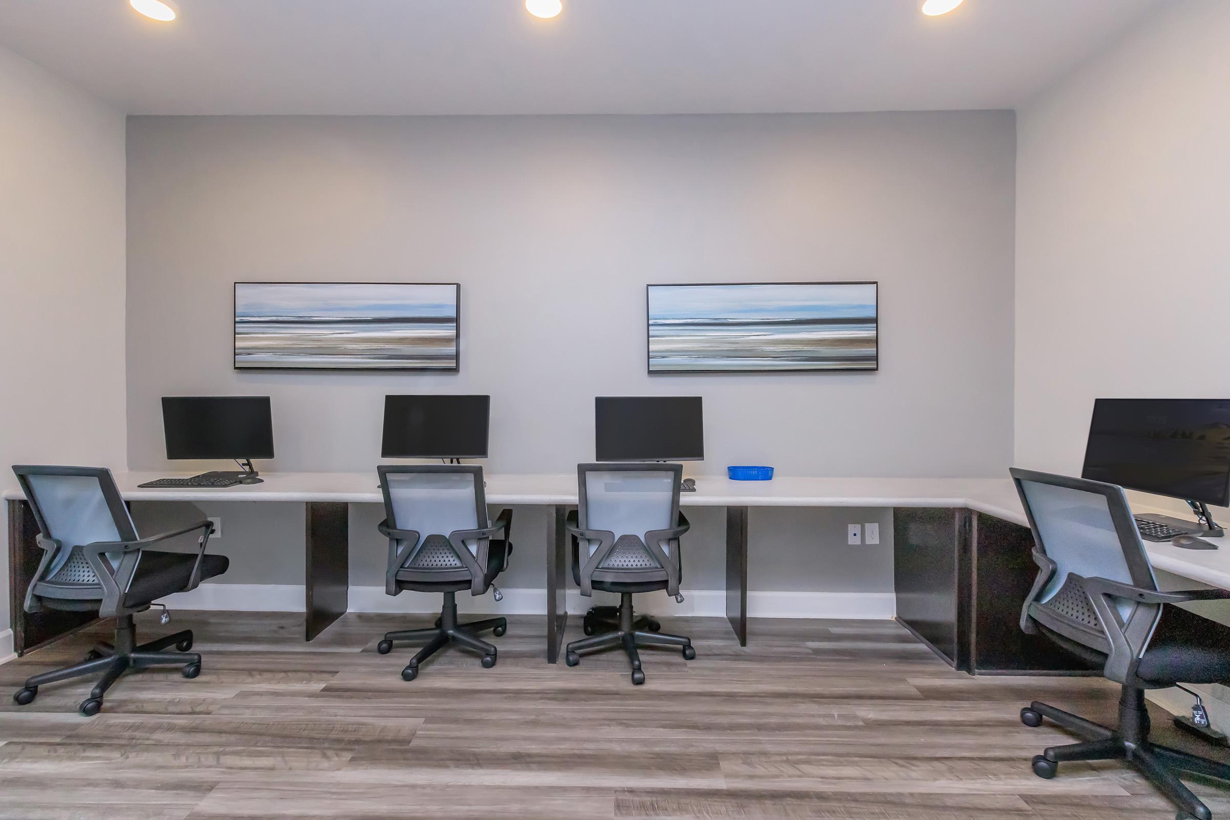 a living room with a desk and chair