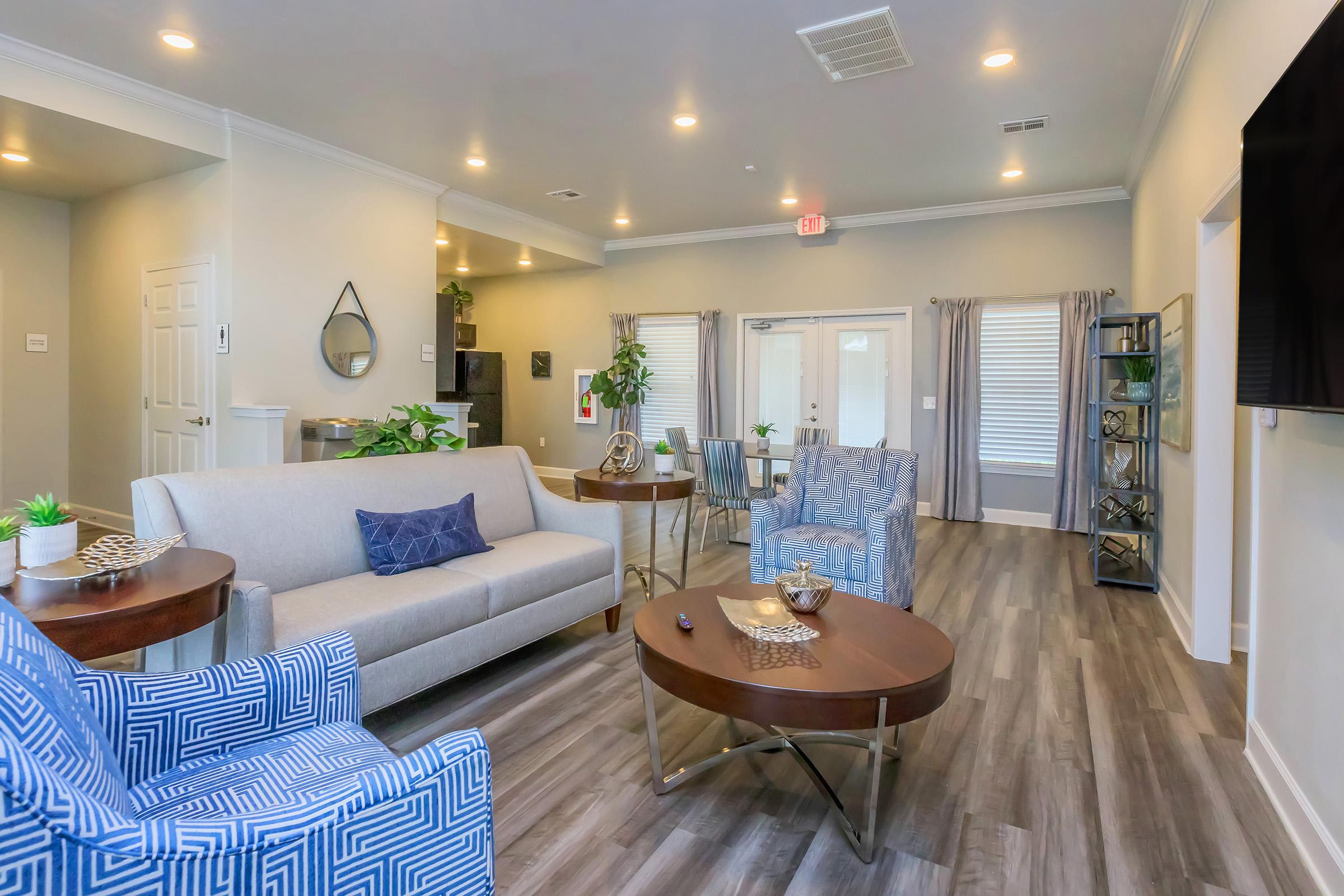 a living room filled with furniture and a large window