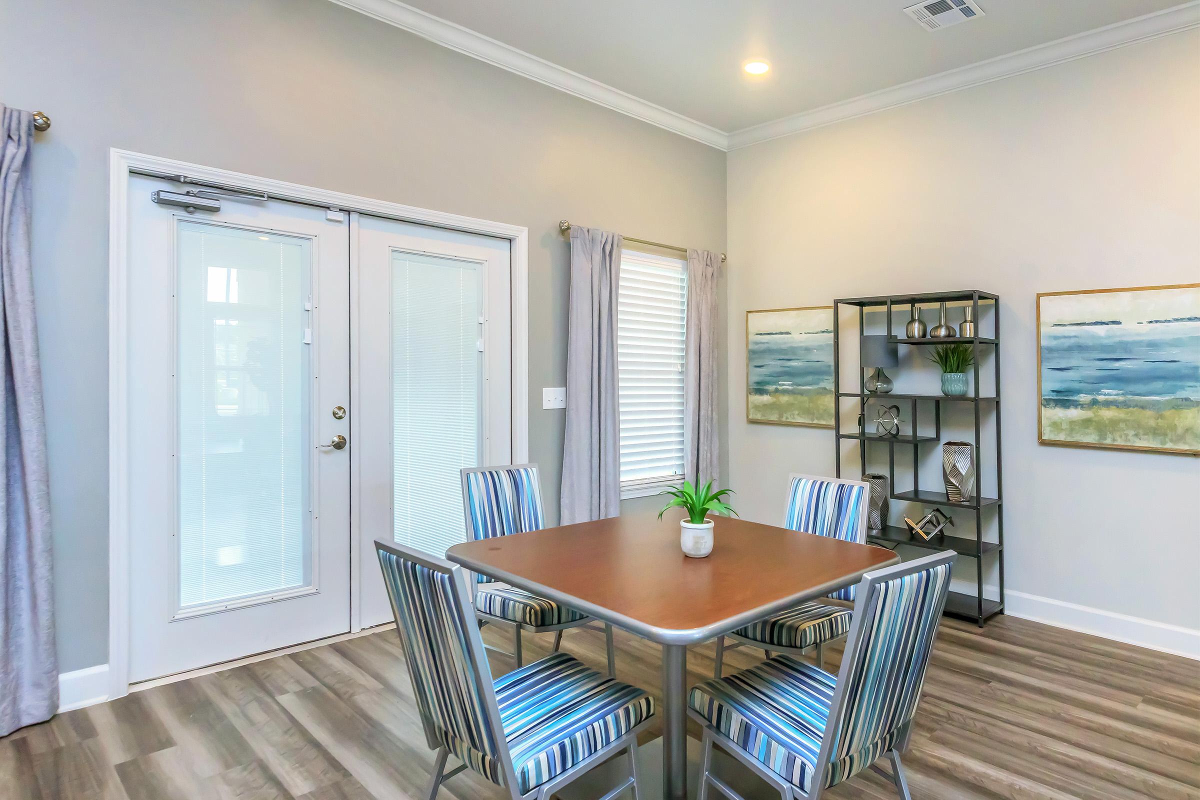 a living room filled with furniture and a large window