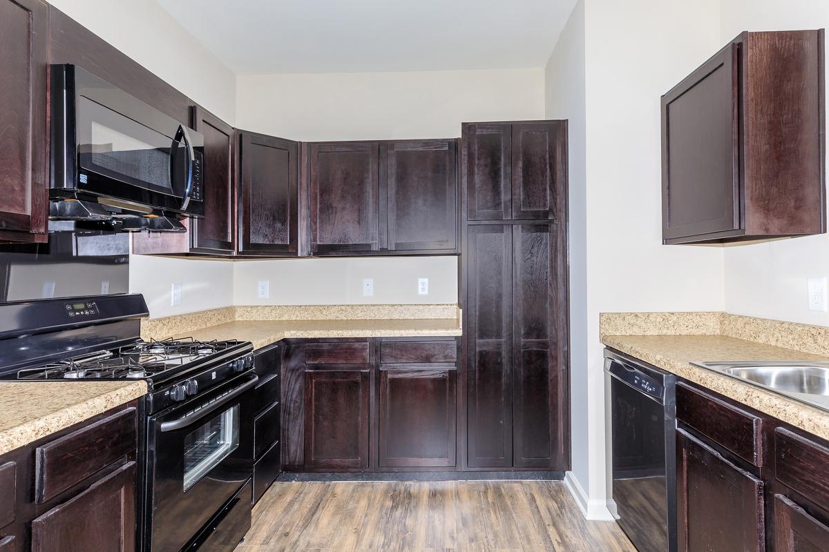 a kitchen with stainless steel appliances and wooden cabinets