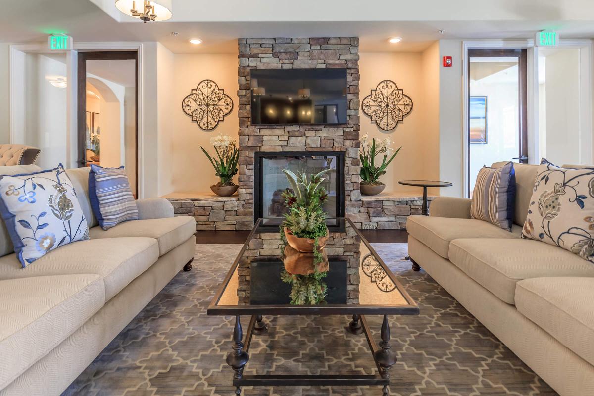 a living room filled with furniture and a fire place