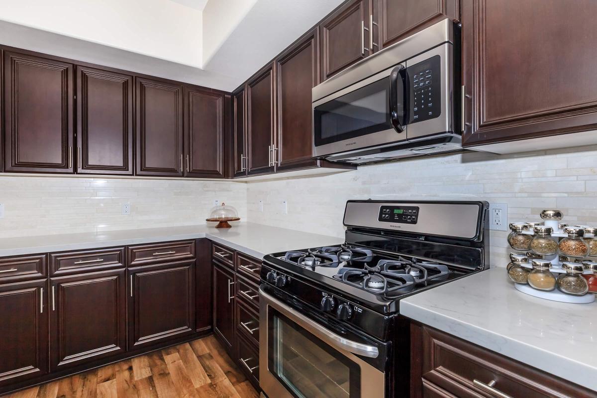 a stove top oven sitting inside of a kitchen