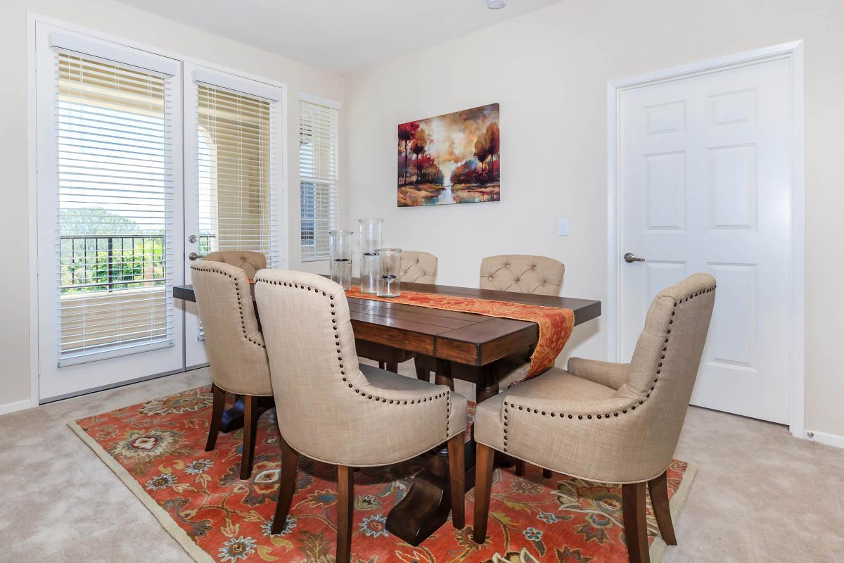 a living room filled with furniture and a large window