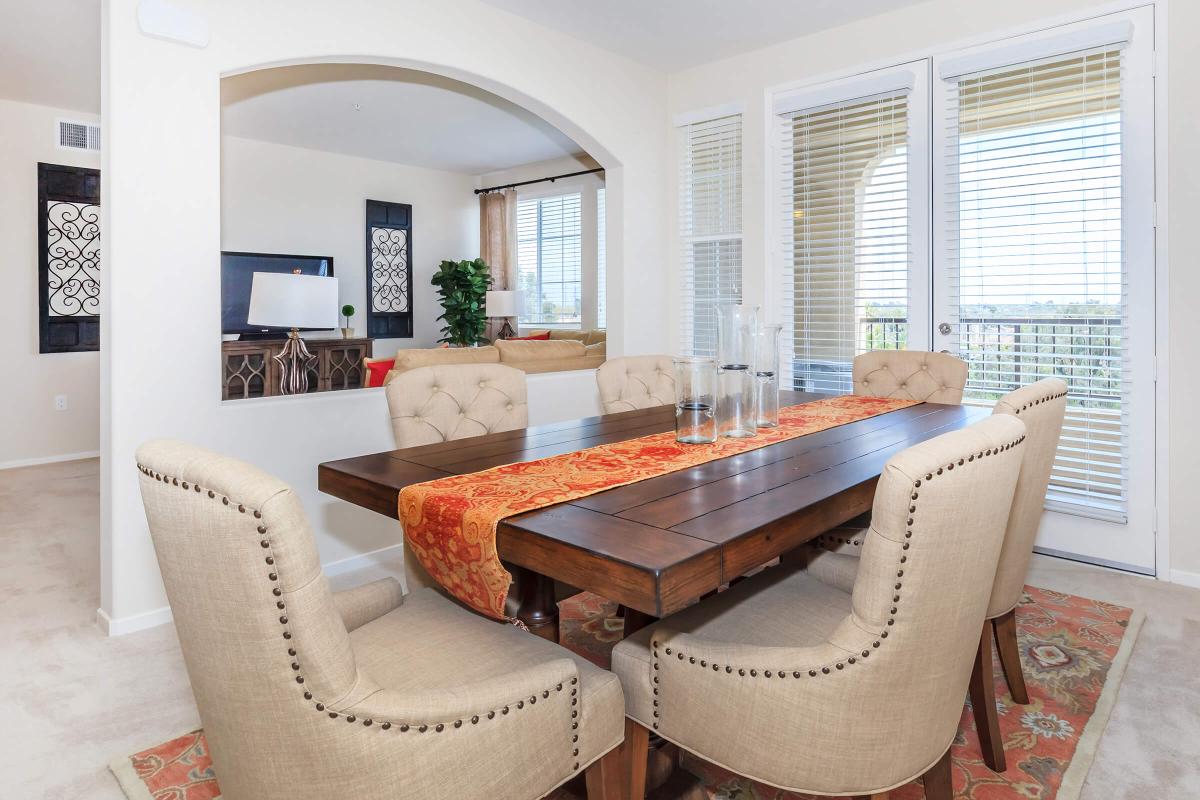 a living room filled with furniture and a large window