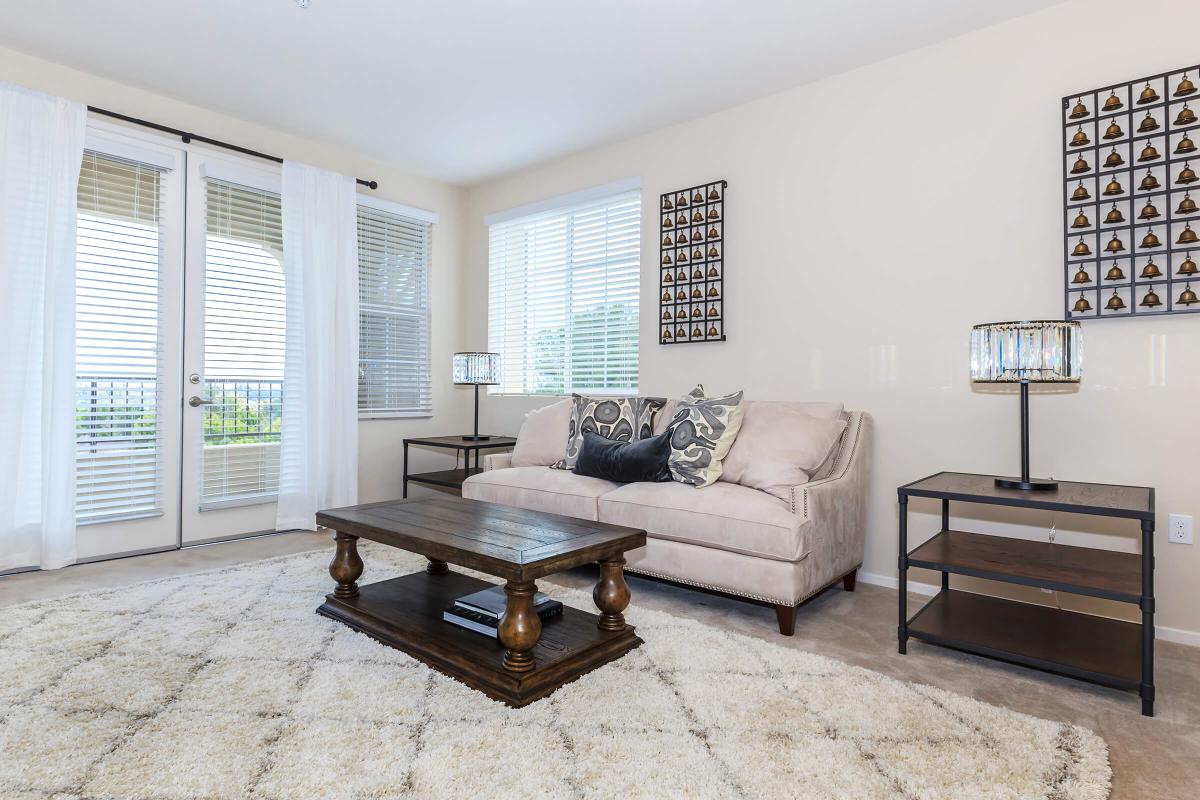 a living room filled with furniture and a large window