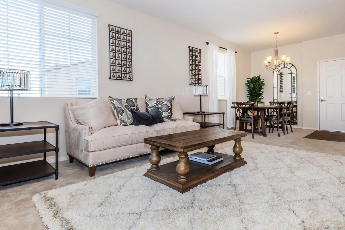 a living room filled with furniture and a large window