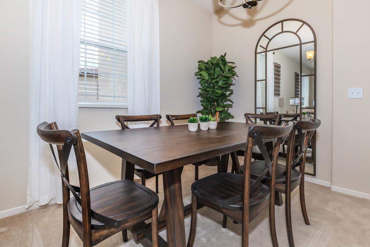 a kitchen with a table and chairs in a room