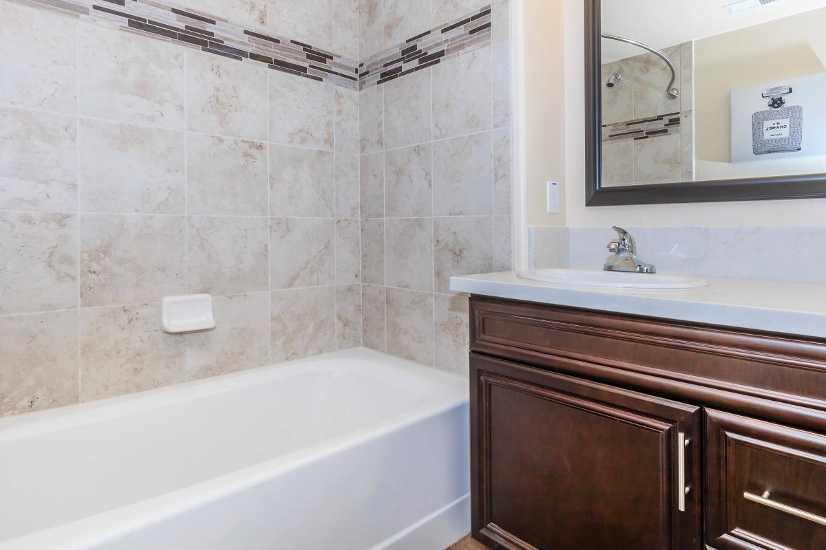 a white tub sitting next to a sink