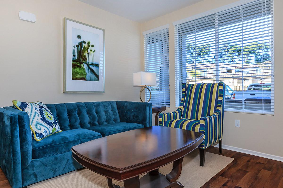 a living room filled with furniture and a large window