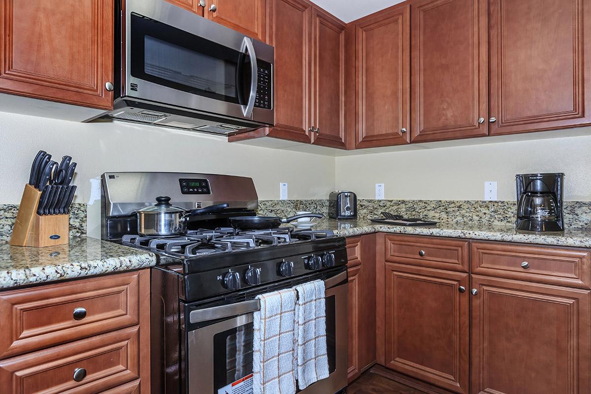 a kitchen with stainless steel appliances and wooden cabinets