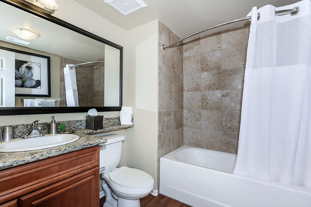 a large white tub sitting next to a sink