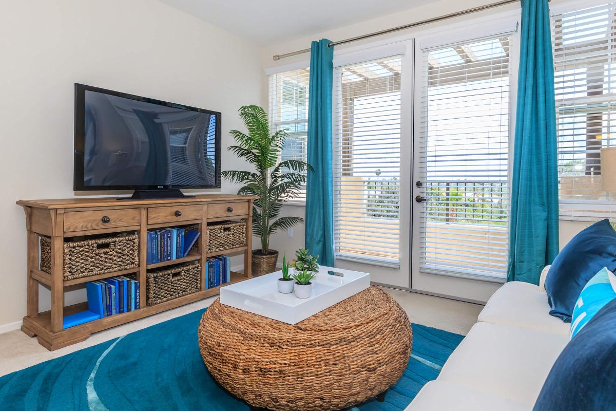 a room with a couch and table in front of a window