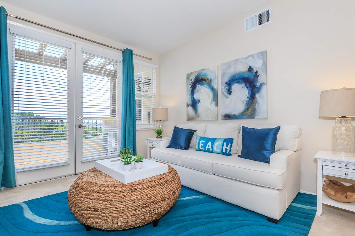 a living room with a bed and a window