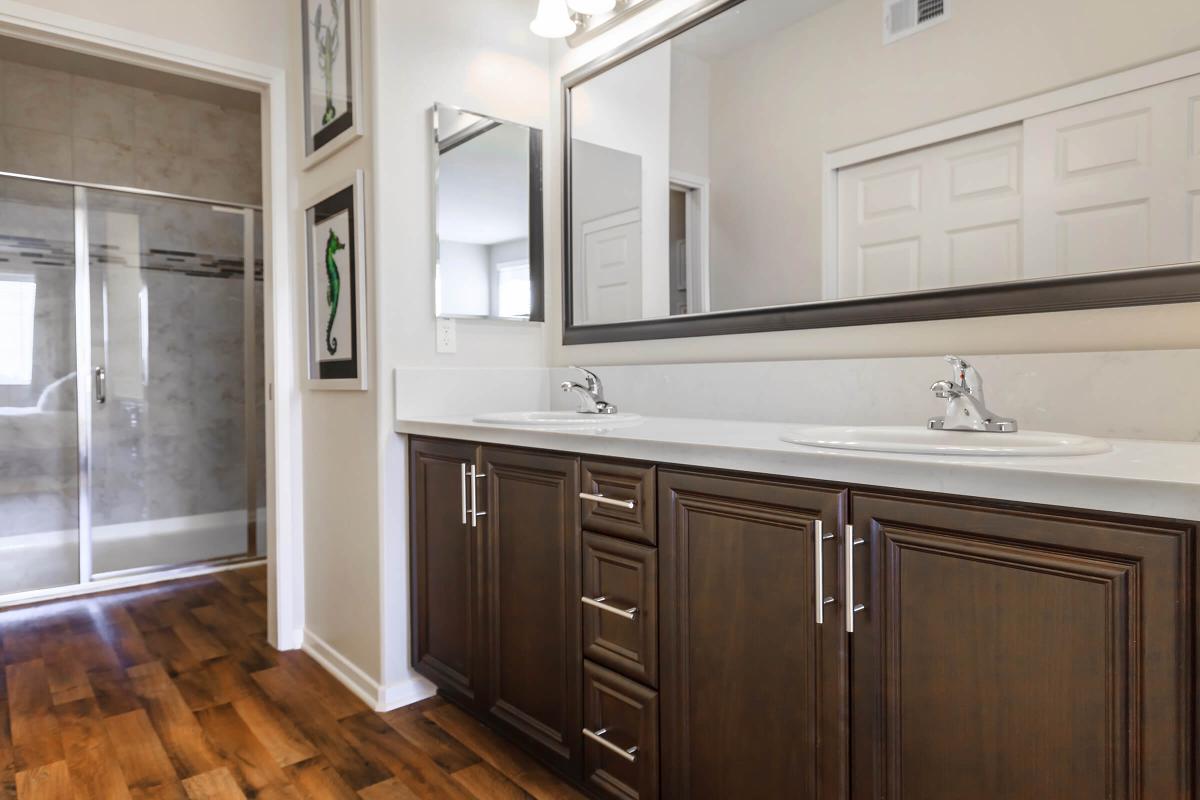 a large kitchen with stainless steel appliances and wooden cabinets