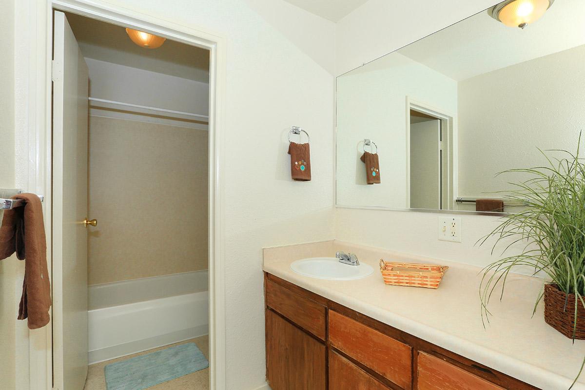 bathroom with sink and door leading to tub and shower.