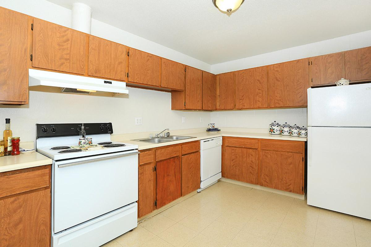 a kitchen with a stove and a refrigerator