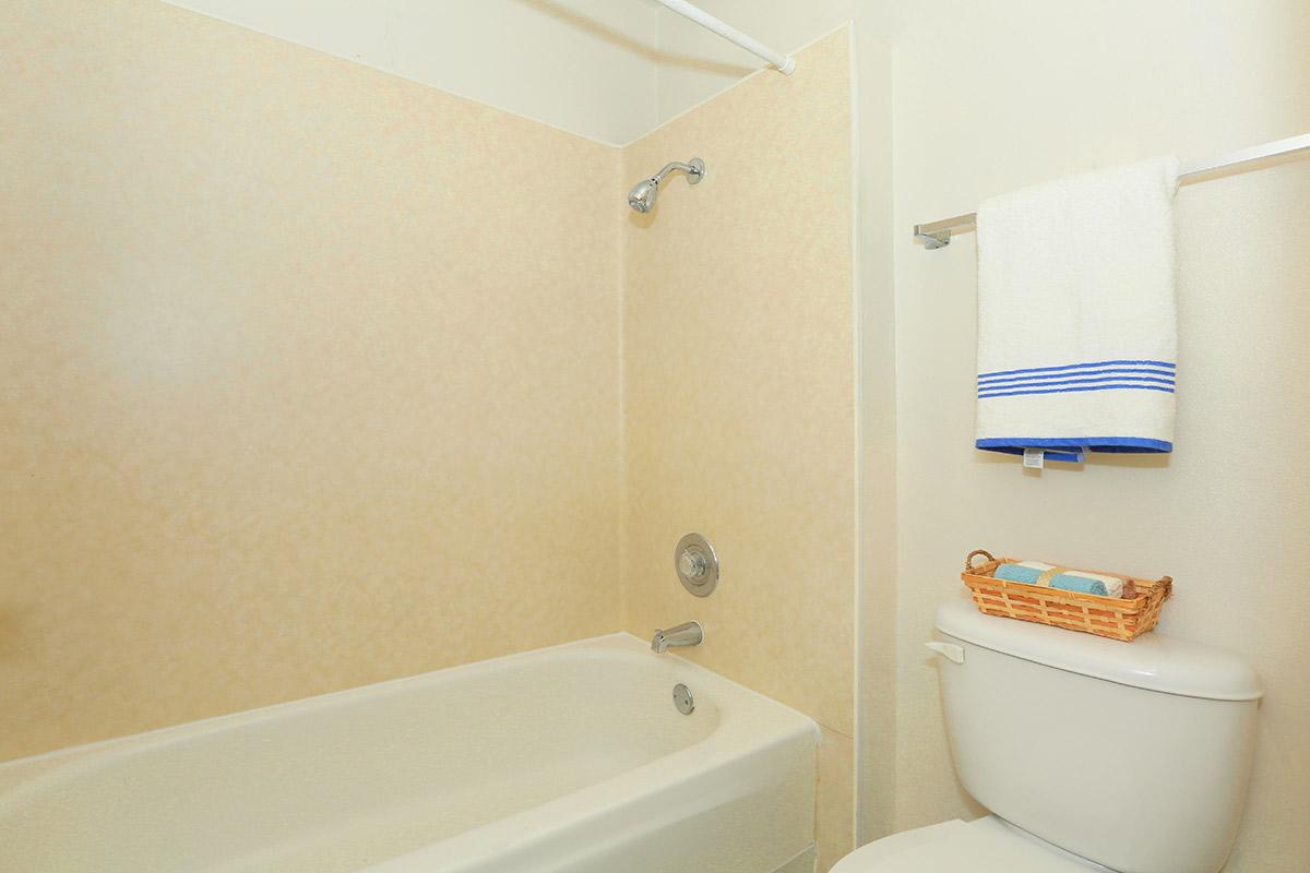 a white tub sitting next to a sink