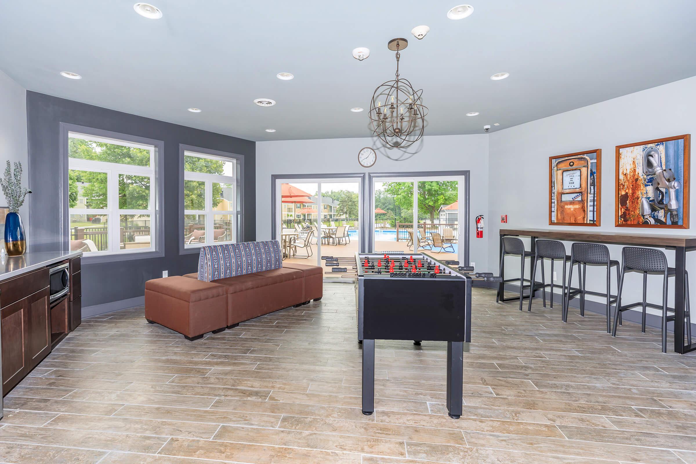 a living room filled with furniture and a large window