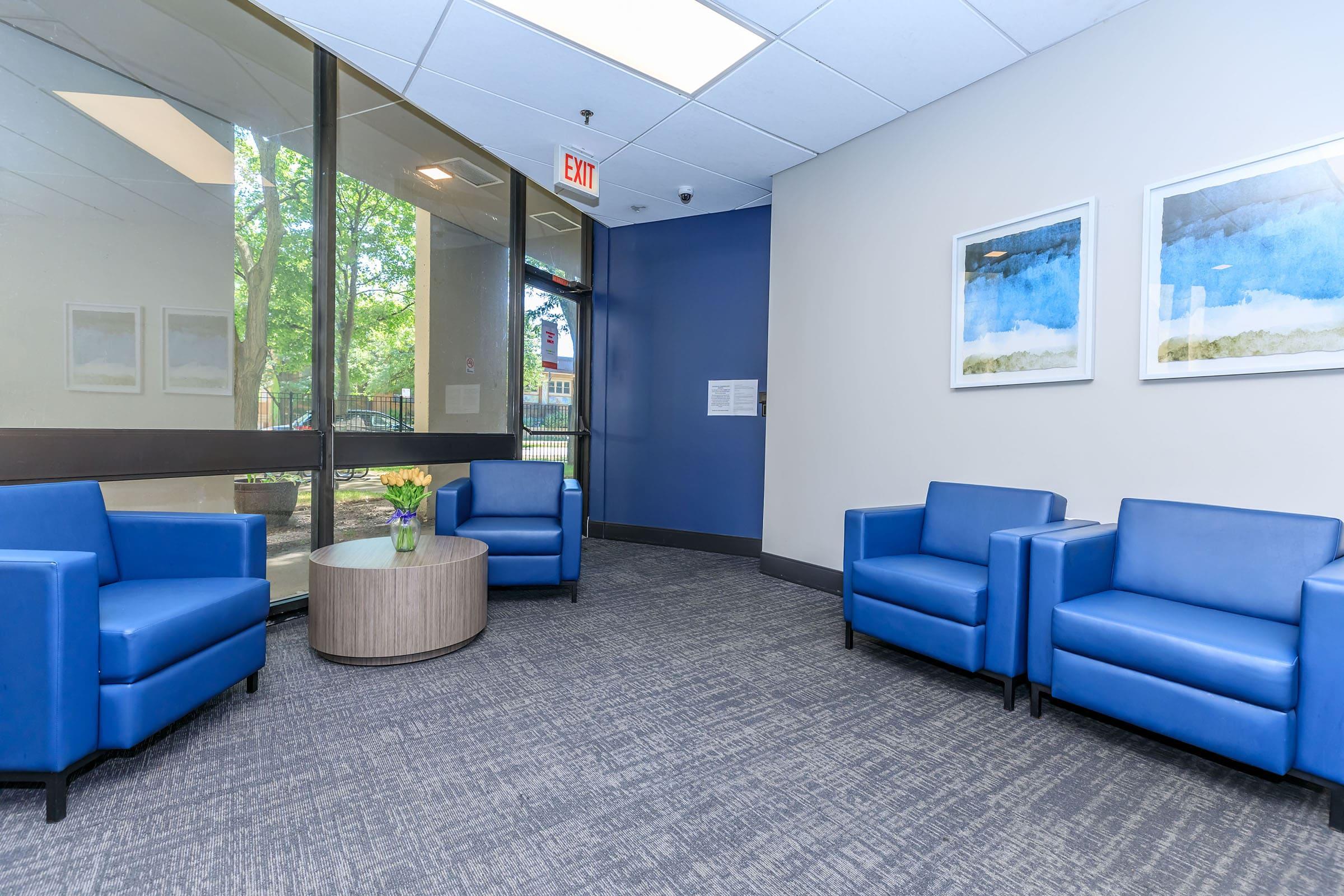 a room filled with furniture and a blue suitcase