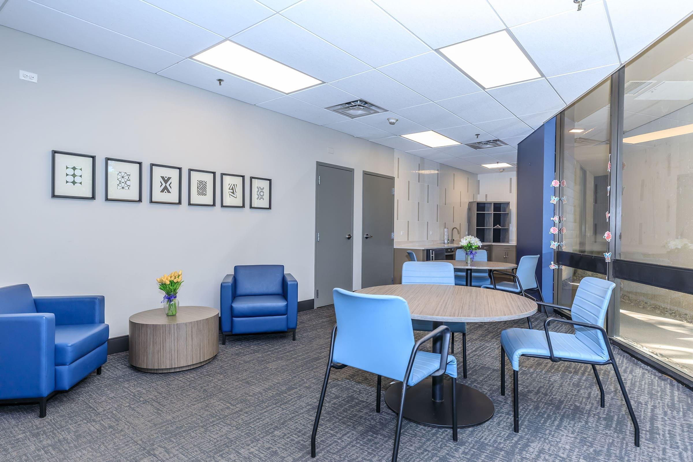 a room filled with furniture and a blue chair