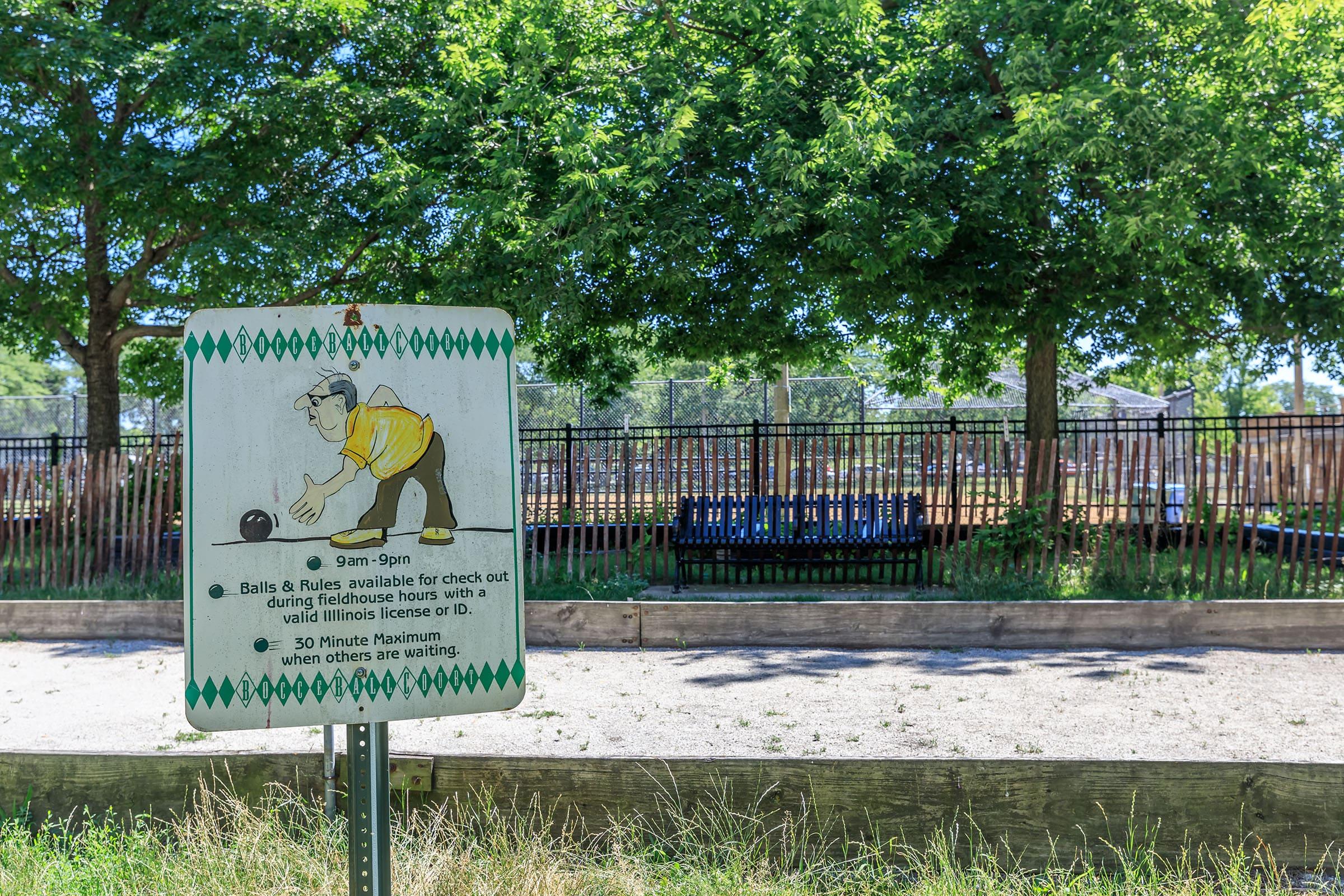 a sign on the side of a fence