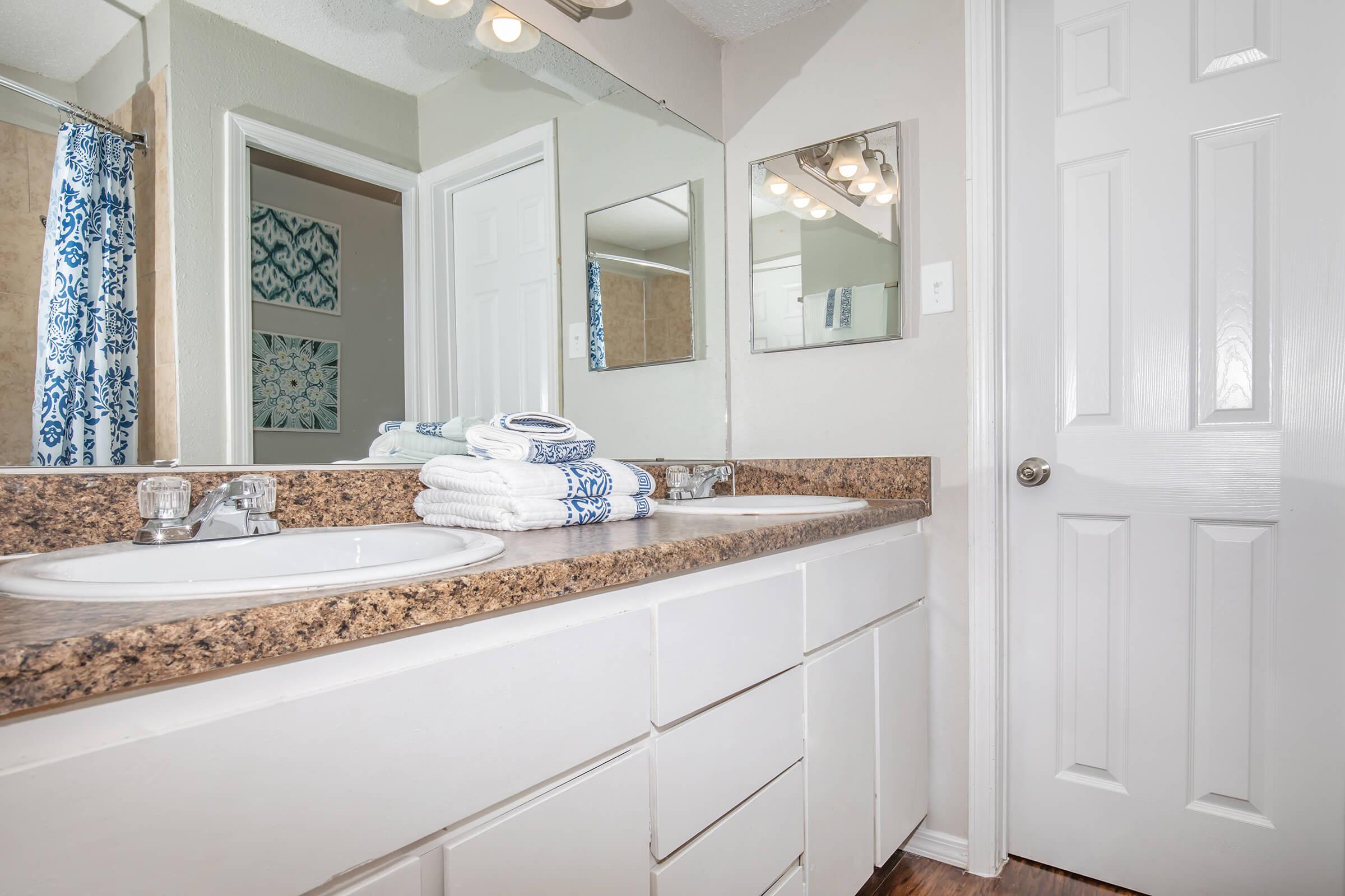 a white sink sitting under a window