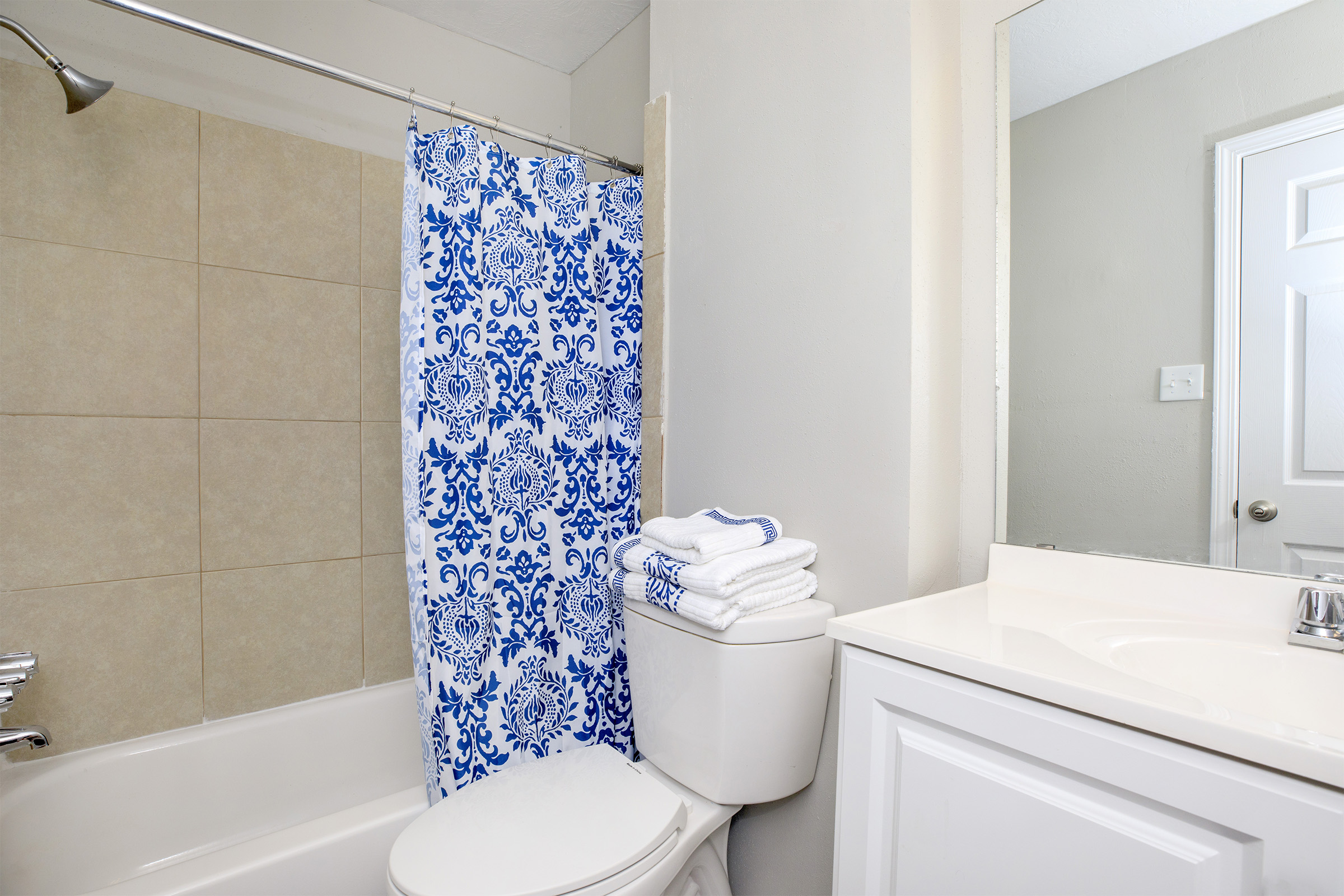 a white tub sitting next to a sink