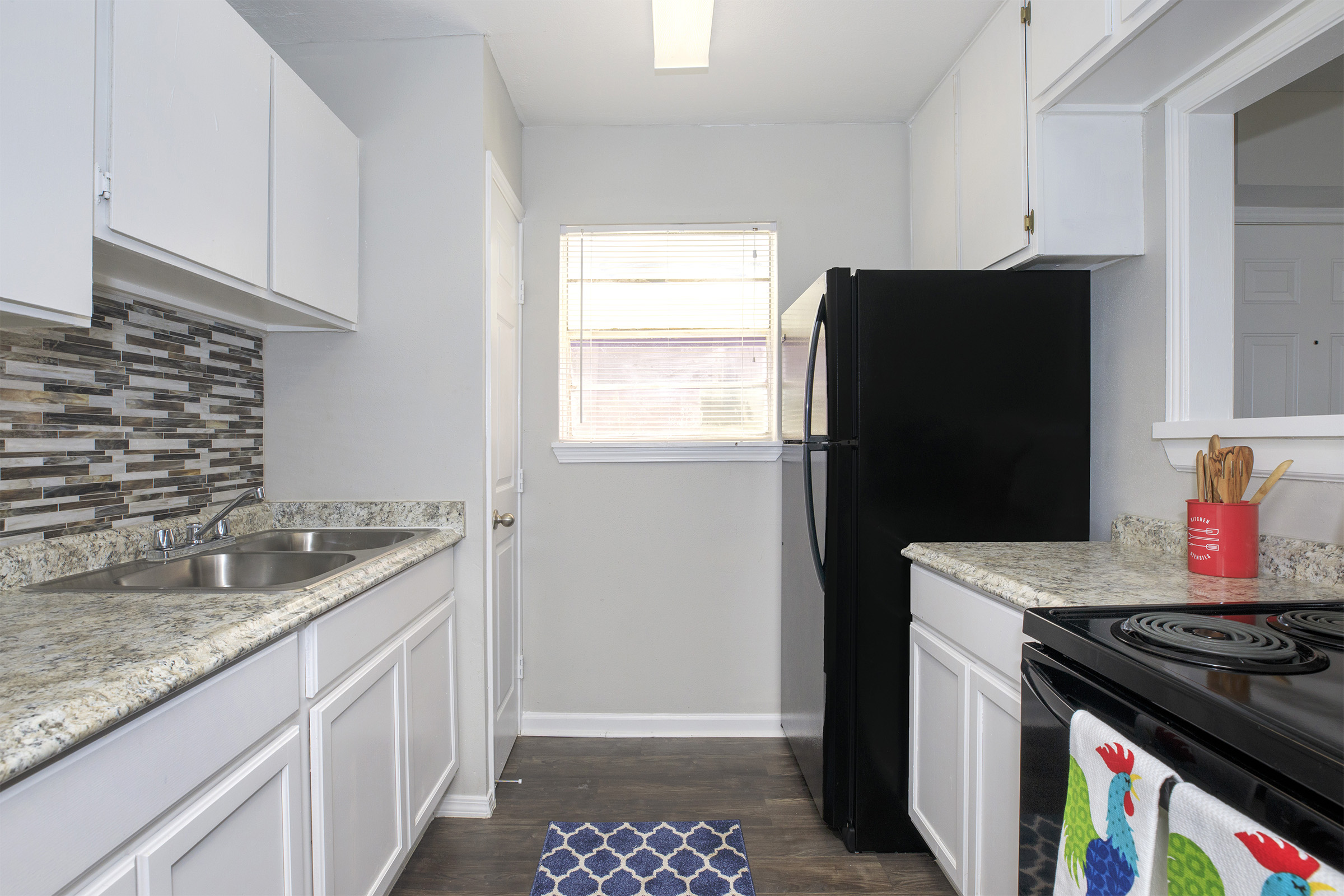 a kitchen with a sink and a refrigerator