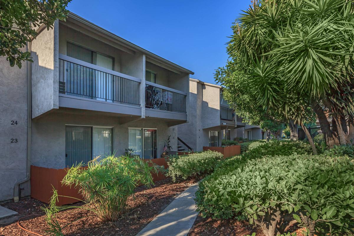 a house with bushes in front of a building