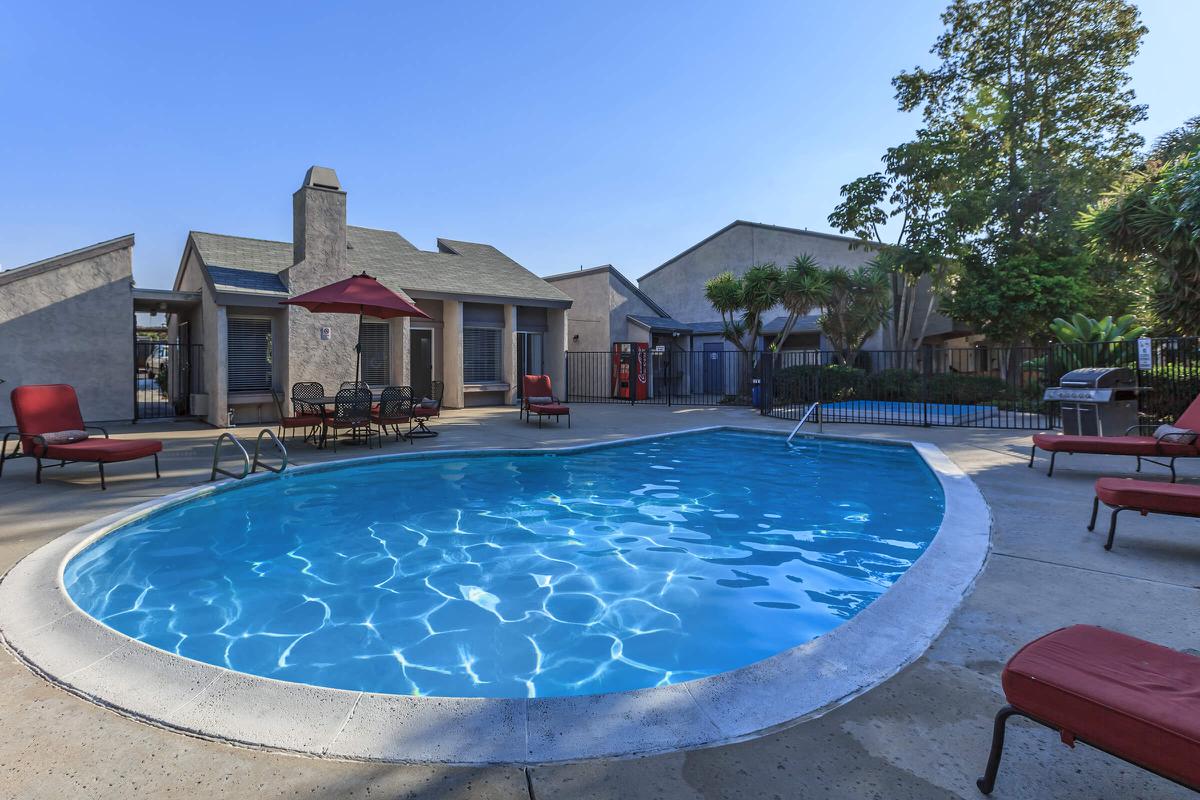 a group of lawn chairs sitting on top of a blue pool of water