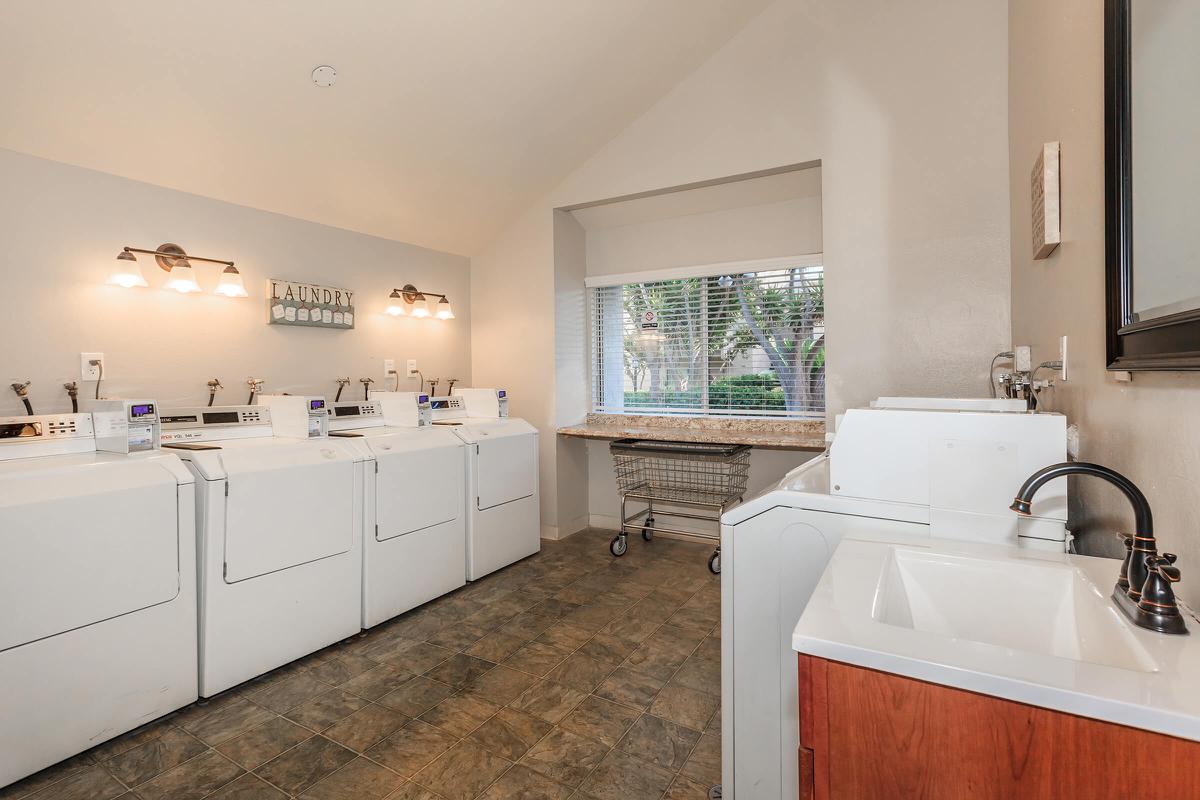 a kitchen with a sink and a mirror