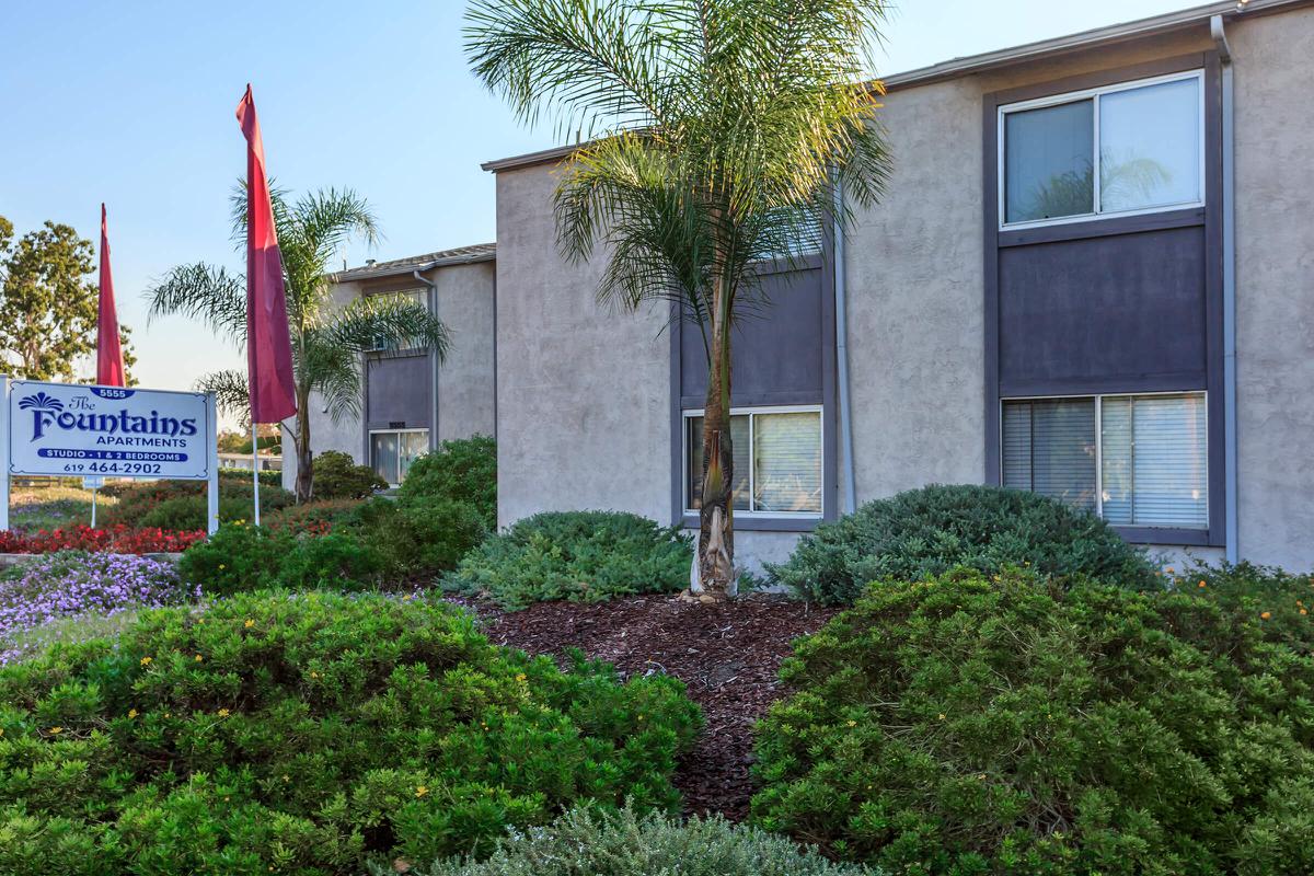 a house with bushes in front of a building