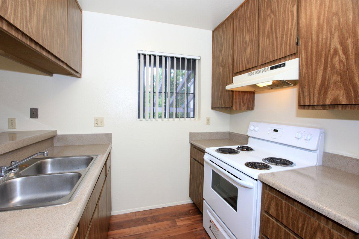 a kitchen with a stove a sink and a microwave