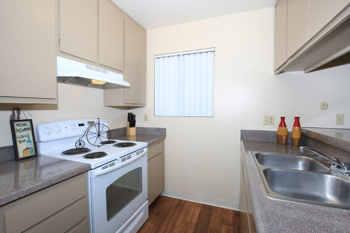 a kitchen with a stove a sink and a microwave