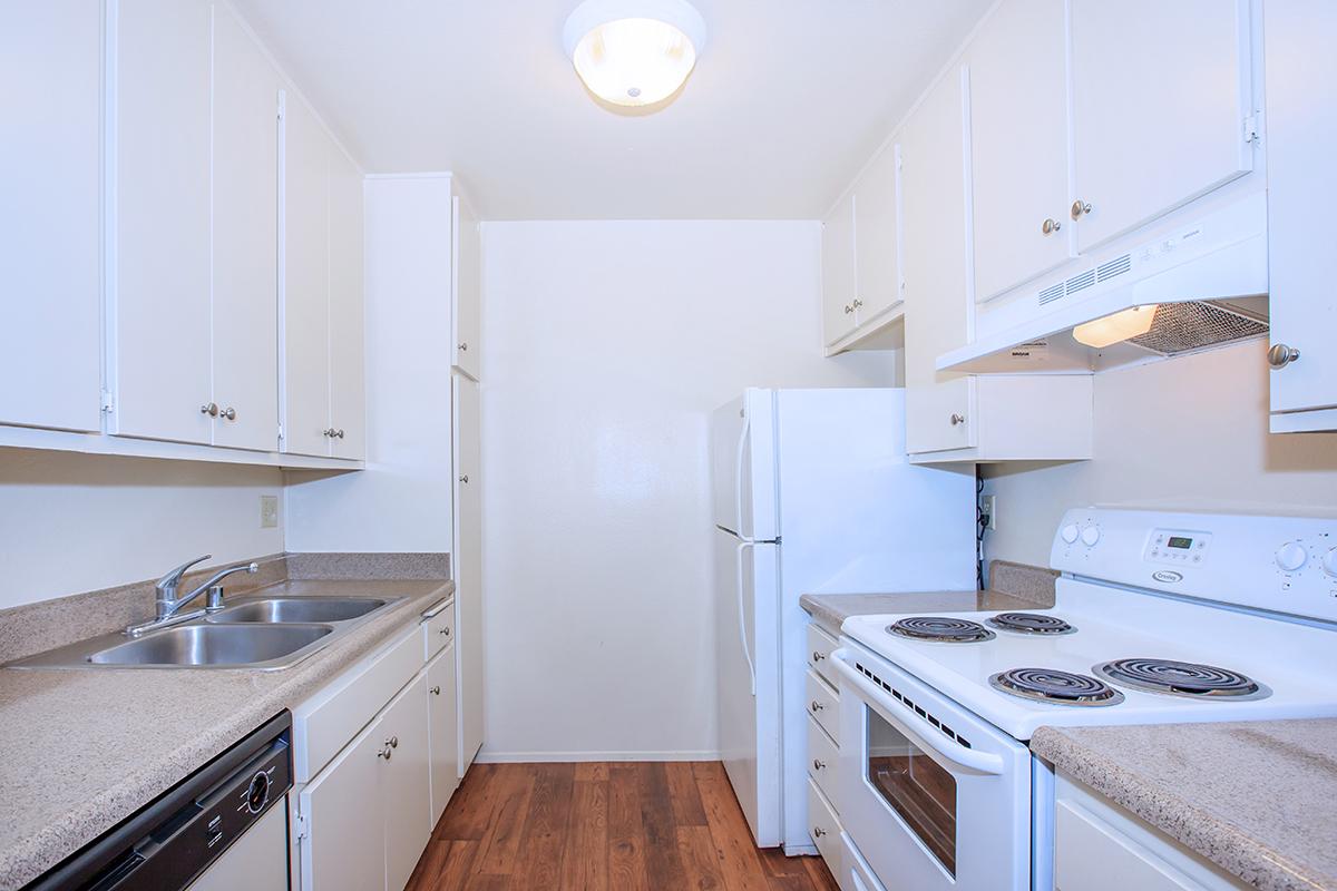 a kitchen with a stove and a refrigerator