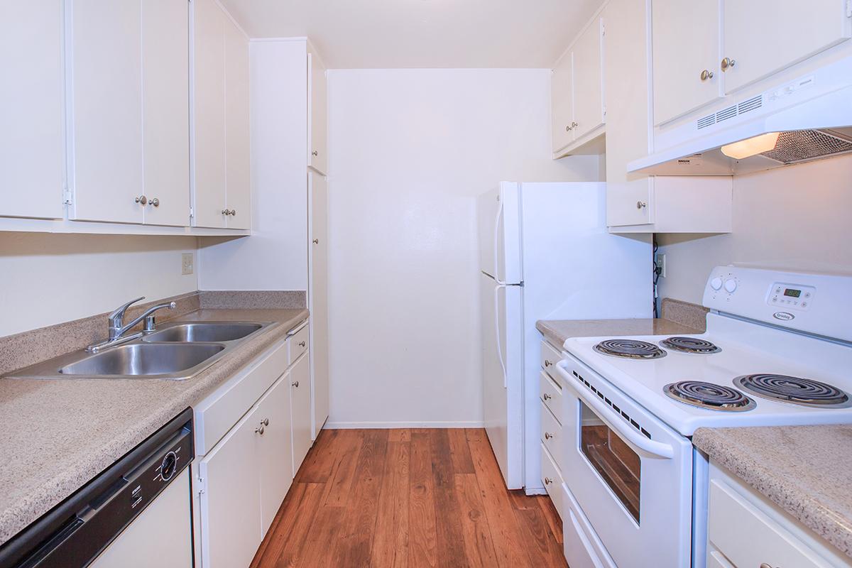 a kitchen with a white stove top oven