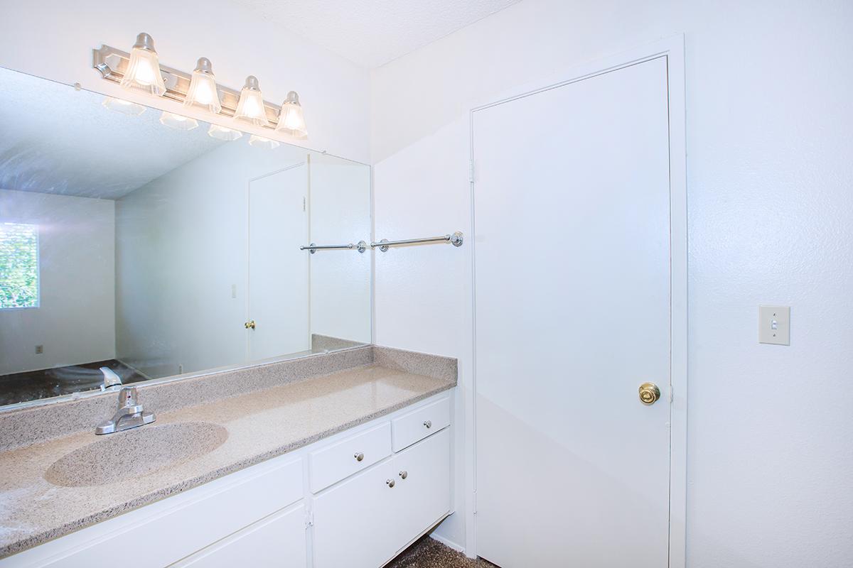 a kitchen with a sink and a mirror