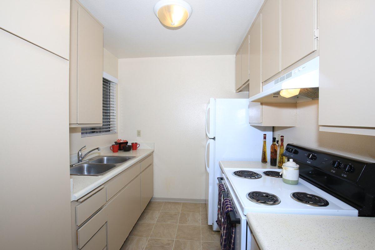 a kitchen with a stove sink and refrigerator