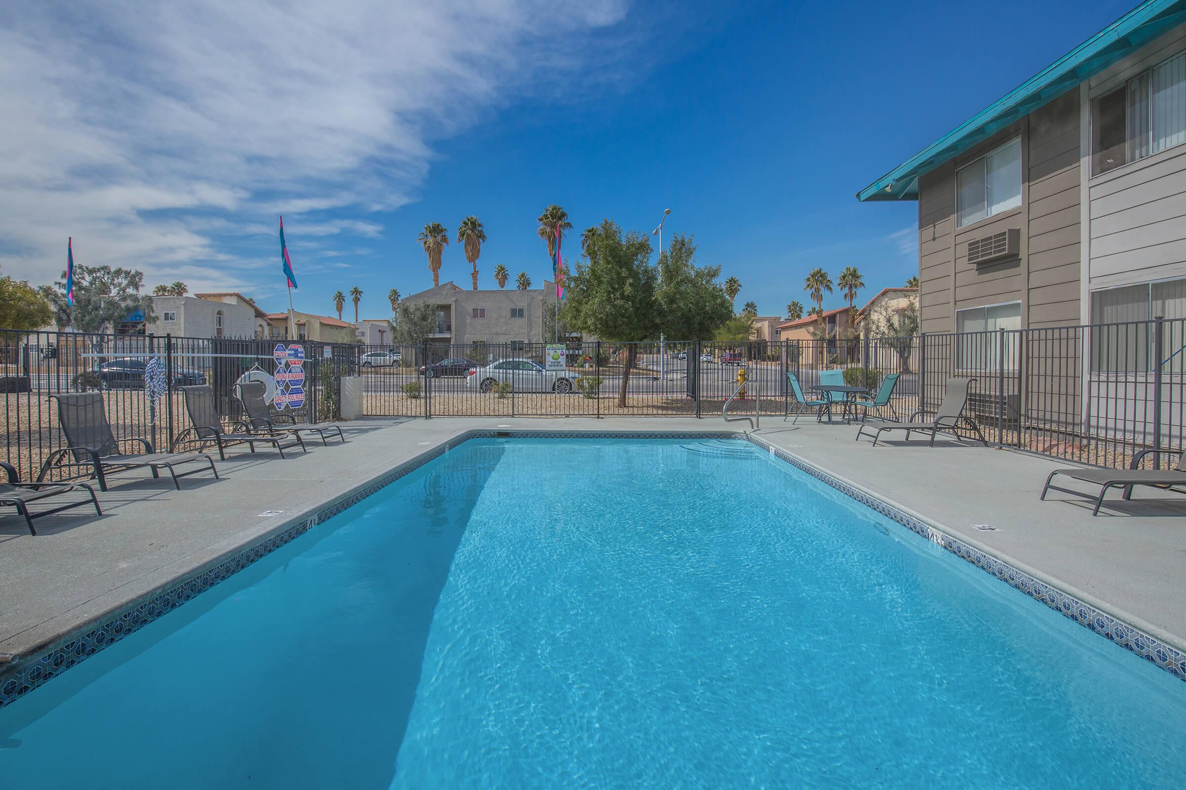 Take a dip in the shimmering pool at Woodhaven Apartments in Las Vegas, Nevada
