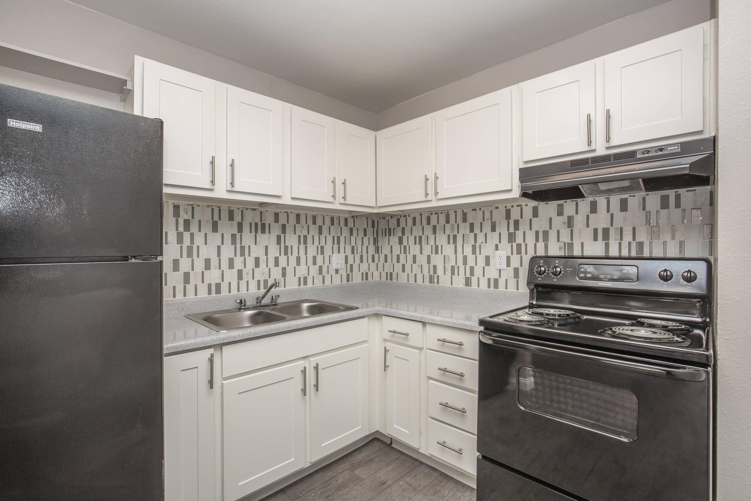 a stove top oven sitting inside of a kitchen