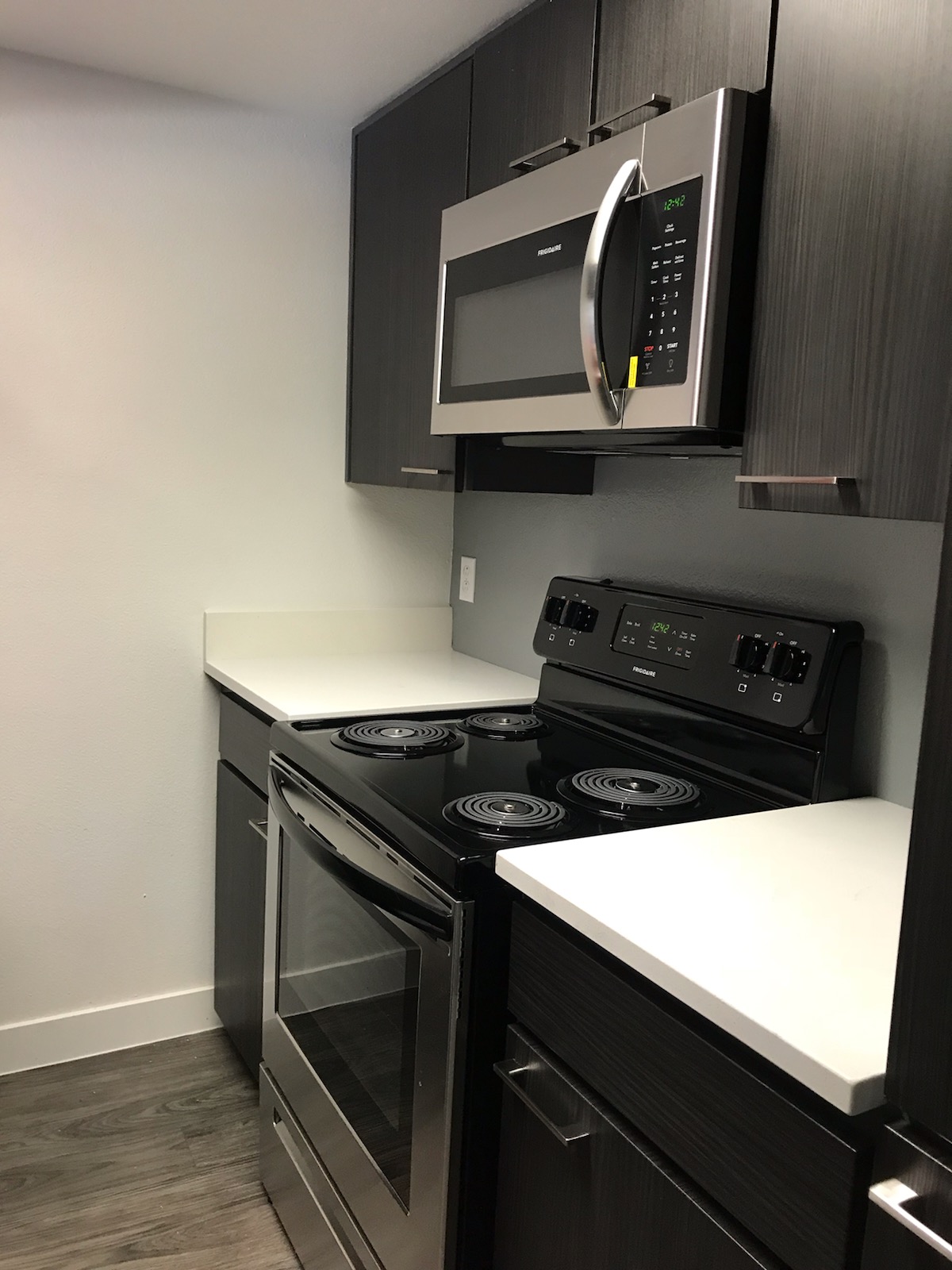 a stove top oven sitting inside of a kitchen