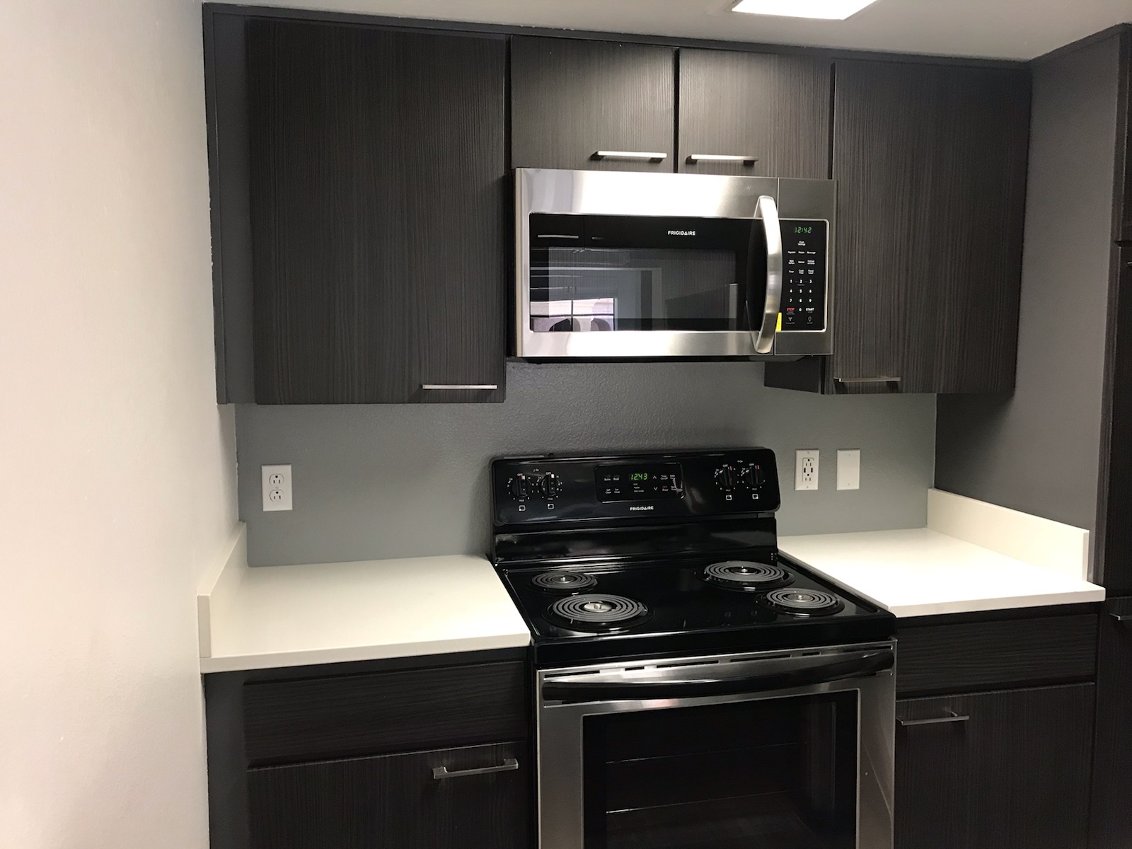 a black stove top oven sitting inside of a kitchen