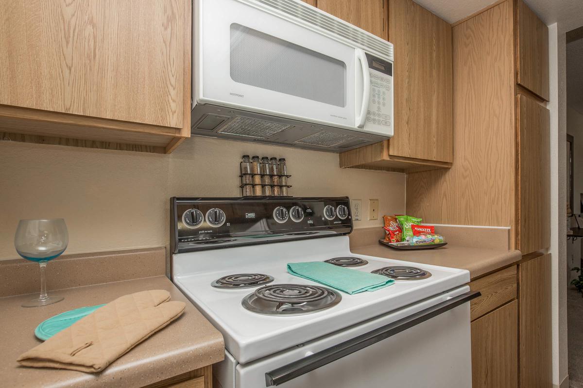 a white microwave oven sitting on top of a stove