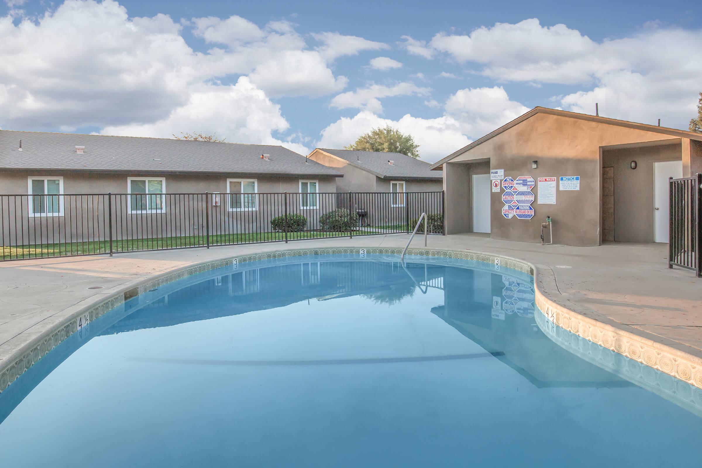 a house with a pool in front of a building